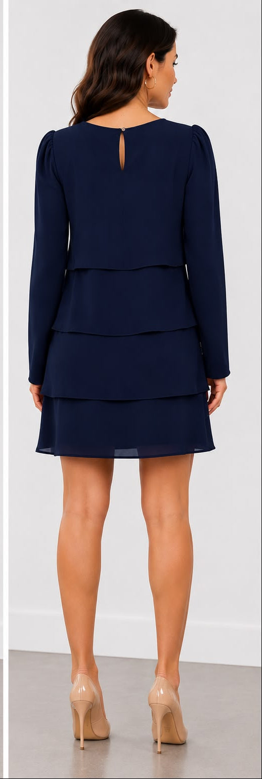 A woman modeling a navy blue long-sleeve mini dress with a tiered ruffle skirt, shown in front and back views against a clean indoor studio background.