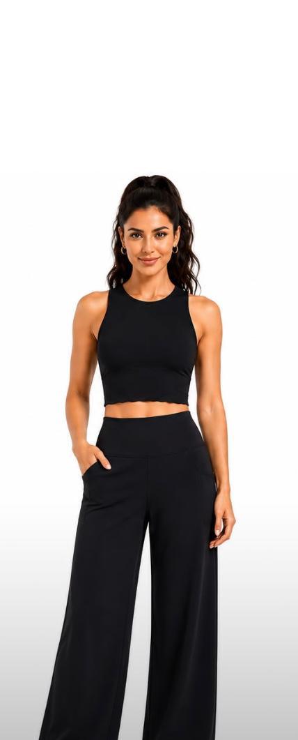 Woman wearing a black sleeveless top and wide-leg pants on a white background