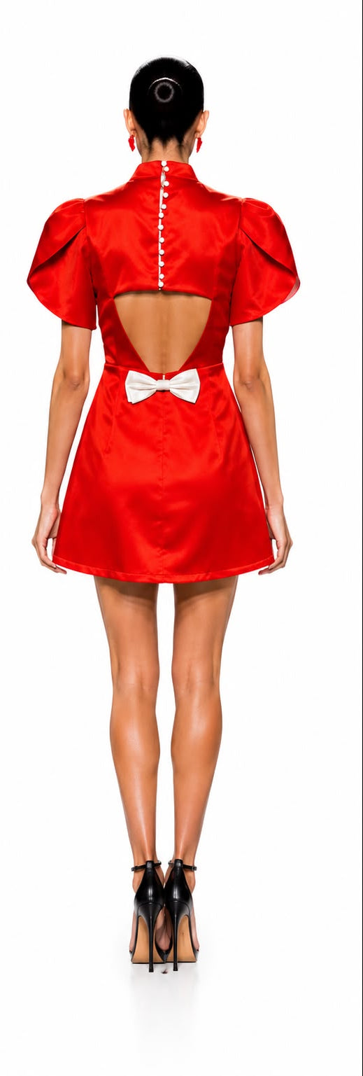 Red dress with puffed sleeves and open back featuring a bow detail, shown from front and back on a white background.