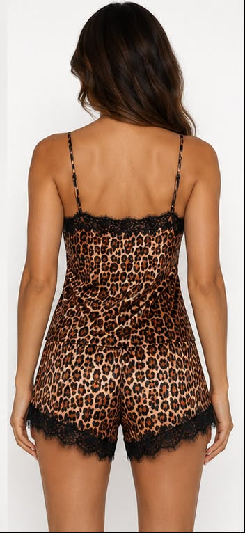 Woman wearing a leopard print lingerie set with lace details on a white background