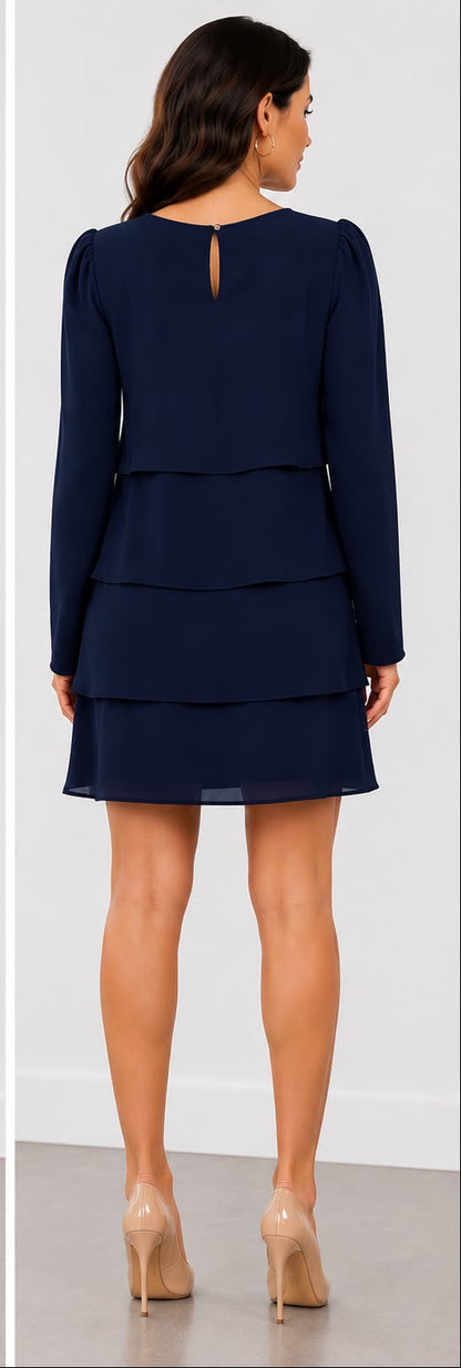 A woman modeling a navy blue long-sleeve mini dress with a tiered ruffle skirt, shown in front and back views against a clean indoor studio background.