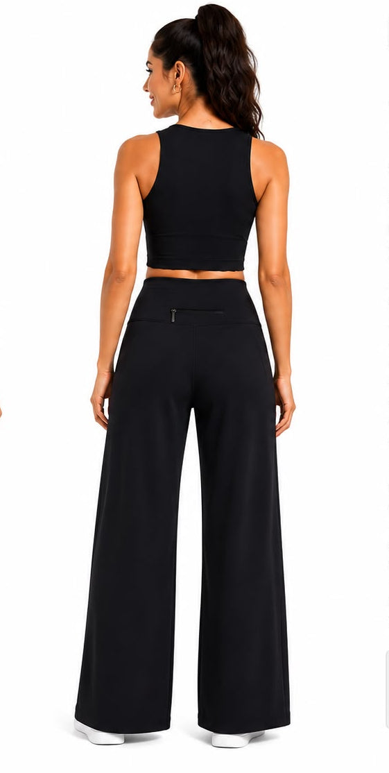Fitolini wide leg performance pants in black with model wearing them on a white background